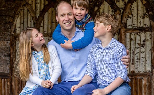 William smiling with his three children