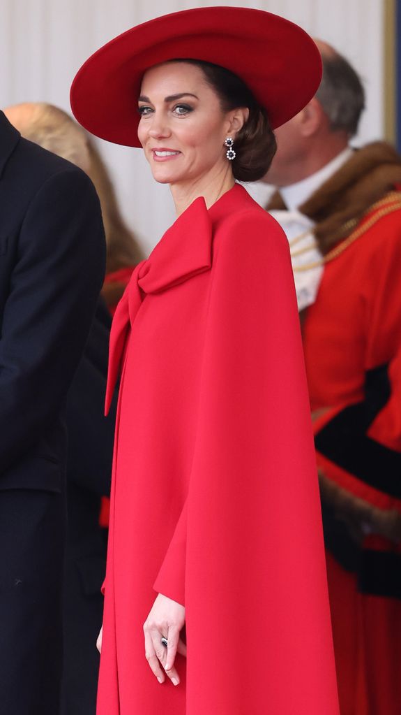 Princess of Wales wearing red hat and red cape