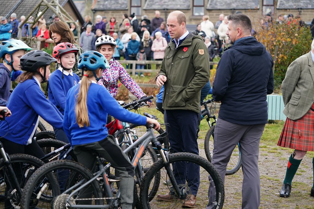Prince William speaks with young cyclist at Outfit Moray