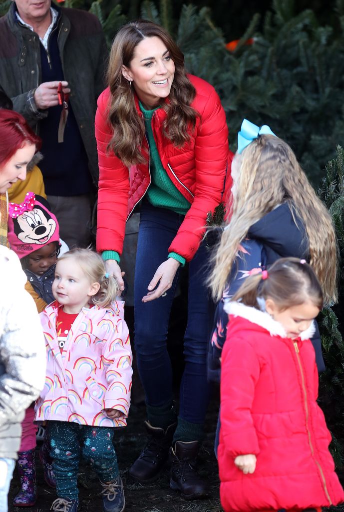 She paired a red puffer coat by Perfect Moment with a bright green sweater by Really Wild for the charity event.
