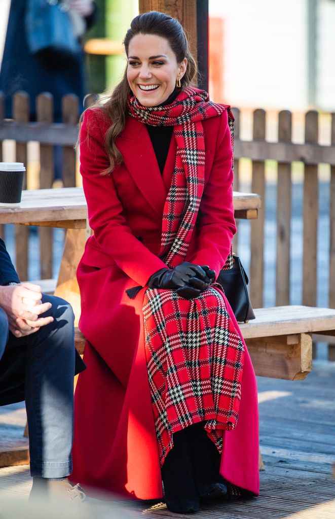 Kate Middleton wears a plaid red scarf and matching red coat for a December 2020 visit to Cardiff, Wales