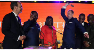 Prince Edward jokingly cutting a cake with unexpected intensity as fans laugh