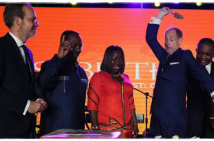 Prince Edward jokingly cutting a cake with unexpected intensity as fans laugh