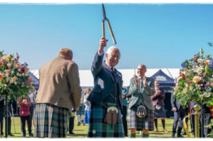 King Charles laughing as he makes a light-hearted joke about cutting his fingers while gardening