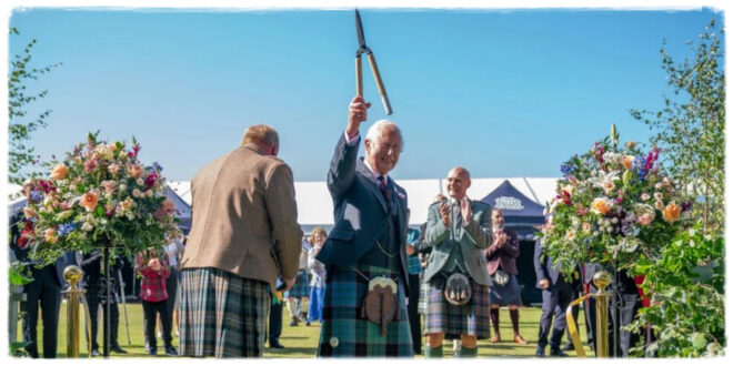 King Charles laughing as he makes a light-hearted joke about cutting his fingers while gardening