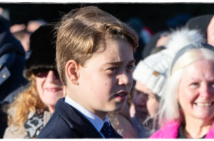 Prince George smiling during the Christmas walkabout after a well-wisher mentioned Princess Diana