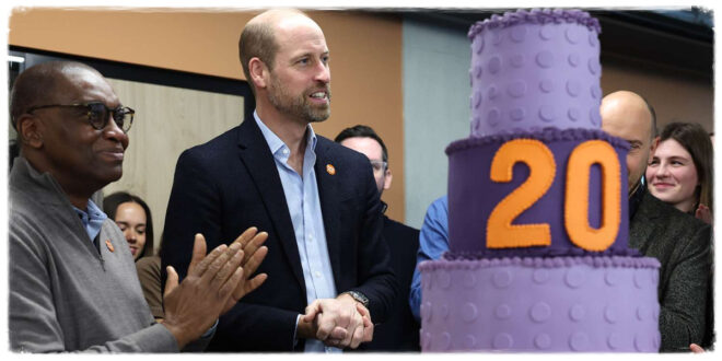 Prince William smiling as he receives an enormous cake to celebrate an important milestone