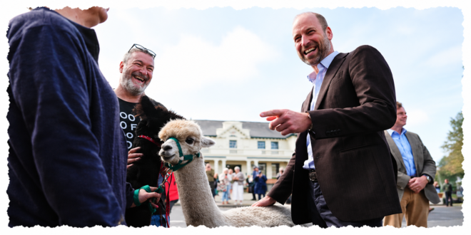 Prince William smiling as he strokes alpacas during his visit to Princetown on Dartmoor